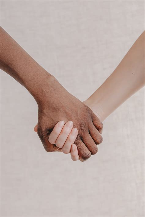 Browse Free HD Images of A Close Up Two People Holding Hands Together