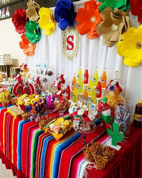 an assortment of food and drinks on a table at a mexican themed birthday party or baby shower