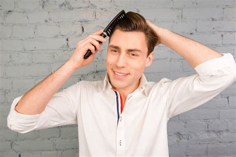 Portrait of Handsome Cheerful Young Man Combing His Hair Stock Image ...