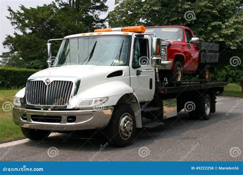 Flat Bed Tow Truck Loading A Broken Vehicle Royalty-Free Stock Photo ...