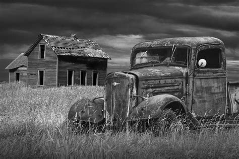 Old Vintage Pickup In Black And White By An Abandoned Farm House Photograph by Randall Nyhof