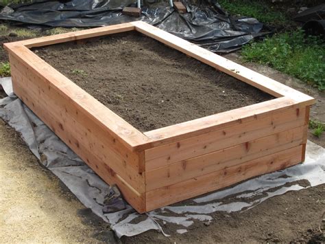 a wooden box with dirt in it on the ground