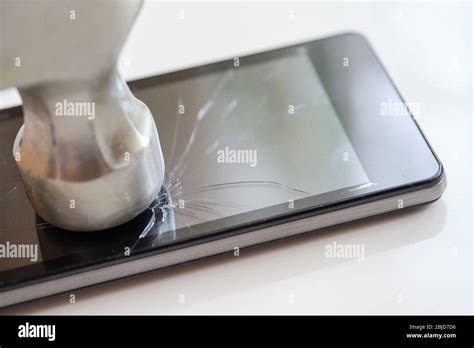 Smartphone display repair concept - abstract smash with a hammer. Close ...