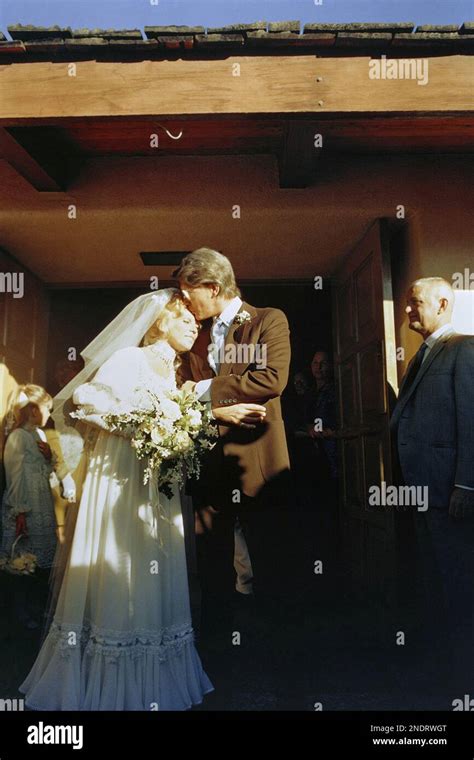 Nancy Sinatra is kissed by her new husband, Hugh Lambert, at their wedding in St. Louis R.C ...