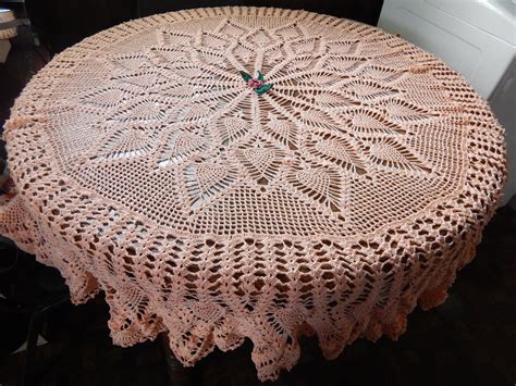 Round Pineapple tablecloth made with center rose in coral and green leaves added. | Crochet ...