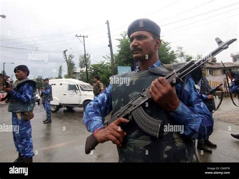 India's Rapid Action Force (RAF) personnel hold weapons during a patrol ...