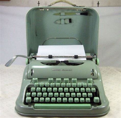 an old - fashioned typewriter is sitting open on a white table with a ...