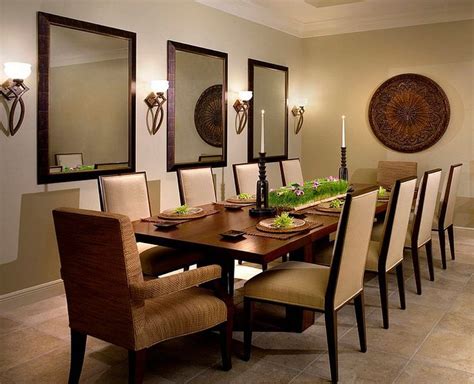 a dining room table with chairs and plates on it in front of two wall sconces