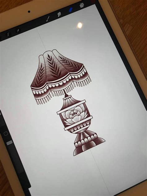 an ipad with a drawing of a lamp on it's screen, sitting on a table