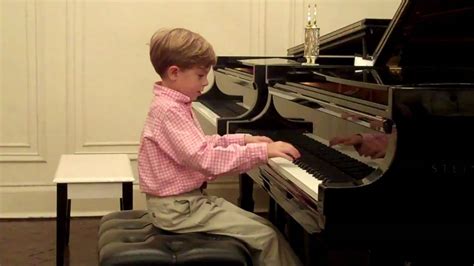 7 year old piano boy plays fireflies - YouTube