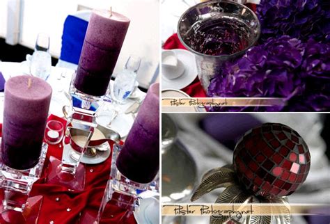 Purple pillar candles, red tablecloth, purple and ruby jewels decorate ...