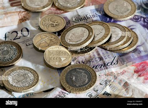 Bank notes and coins of different denominations. British Sterling currency Stock Photo - Alamy