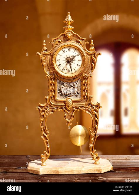 ancient vintage golden brass pendulum clock Stock Photo - Alamy