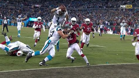 Cam Newton is running through, diving over and destroying the Cardinals ...