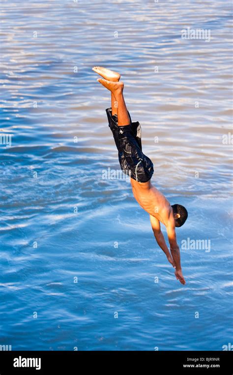 This is an image of a young man diving into the water Stock Photo - Alamy