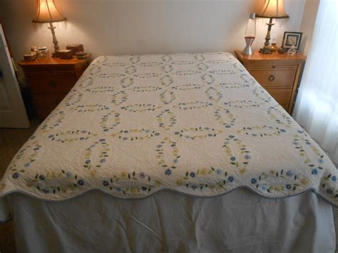 Scalloped Edge White Quilt with Embroidered Flowers by hollister54