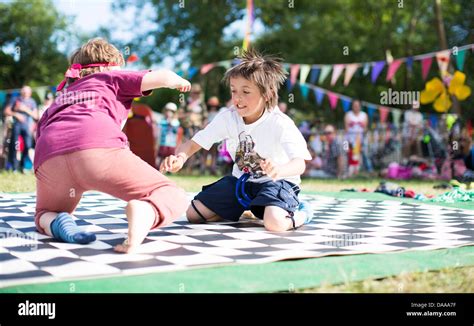 Children take part in a sock wrestling competition in the kids field on the Sunday of ...