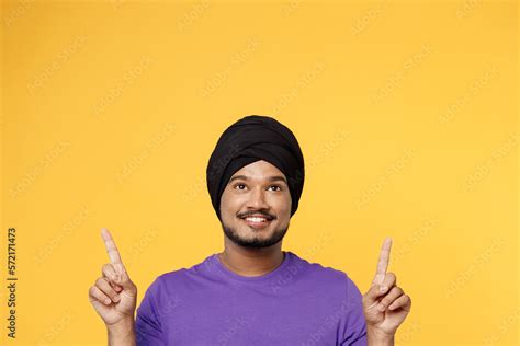 Happy devotee Sikh Indian man ties his traditional turban dastar wear ...