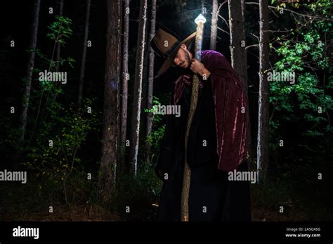 Wizard cosplay with glowing staff and hand during night time in the ...