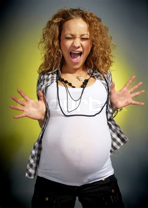 screaming pregnant woman in studio | Stock image | Colourbox