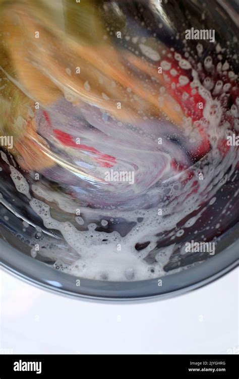 clothes spinning in washing machine Stock Photo - Alamy