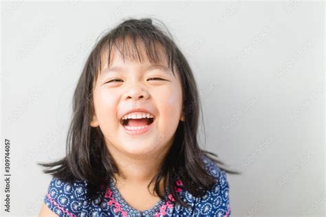 Happy Little asian girl child showing front teeth with big smile and laughing: Healthy happy ...