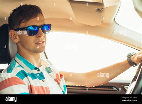 Happy male driver smiling, young man driving his car while sitting in ...