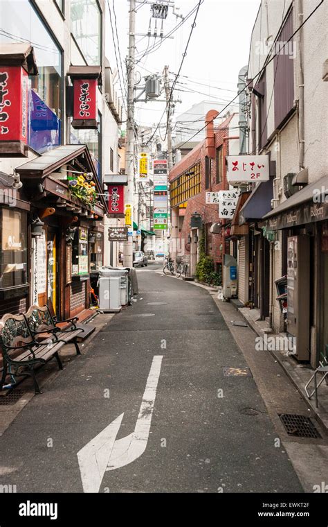 Typical Japanese city street scene. Narrow road between two rows of Stock Photo - Alamy