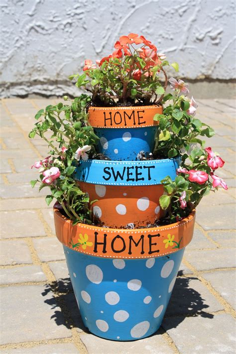 Tiered terracotta pots | Painted flower pots, Terra cotta pot crafts ...