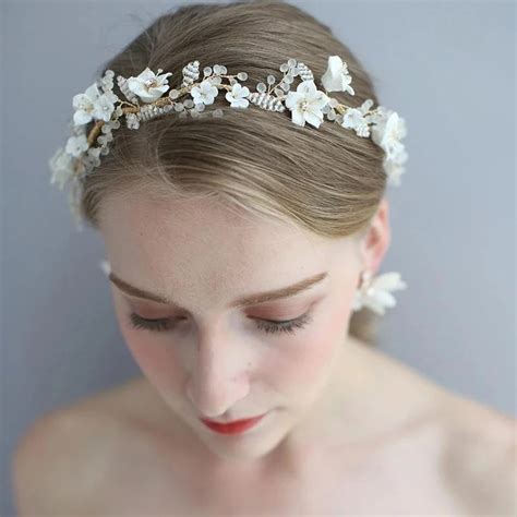 a woman wearing a head piece with flowers on it