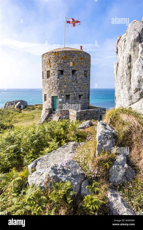 The Guernsey flag flying over Loophole Tower No 5 L'Ancresse (Nid de l'Herbe, Vale), Guernsey ...