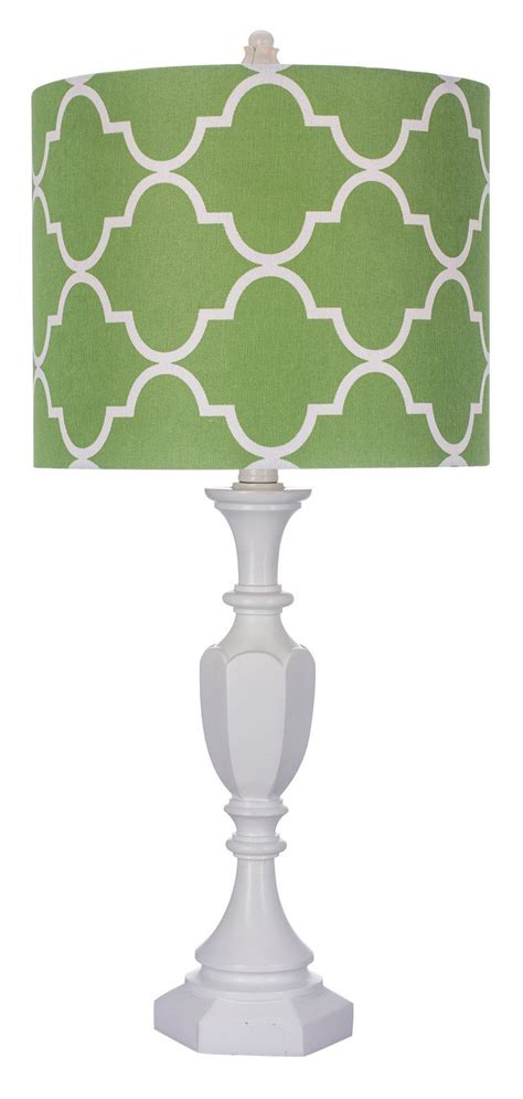 a white table lamp with a green lampshade on the top and bottom of it