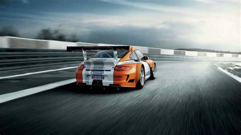 Download Intense Competition at High Speeds in a Racing Game Wallpaper | Wallpapers.com