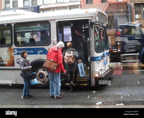 Commuters board an M23 bus in the Chelsea neighborhood of New York on Tuesday, November 10, 2015 ...