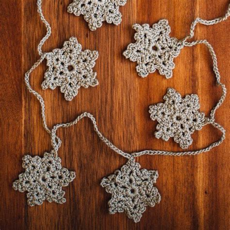 Crochet a wintery garland with snowflakes! Pattern is written in ...