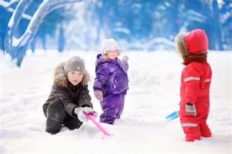 Little Children in Winter Clothes Having Fun in Park at the Snowy Winter Day Stock Image - Image ...