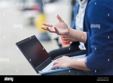 Business people with laptop talking outdoors Stock Photo - Alamy