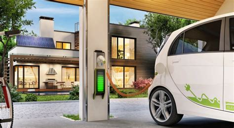 Charging an electric car in the garage near the house. Modern house ...