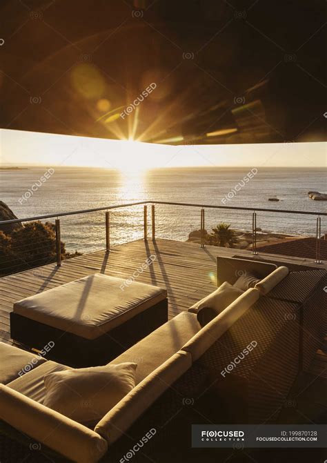 View of sunset over ocean from luxury balcony — house, calm - Stock ...