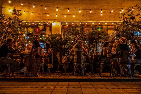 People eating outside the restaurant Photograph by Rick Neves - Pixels