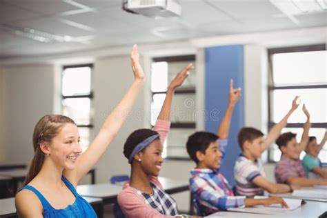 Student Raising Hand in Classroom Stock Image - Image of intelligent ...