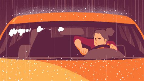 a man driving in the rain behind a car