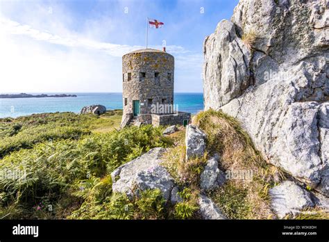 The Guernsey flag flying over Loophole Tower No 5 L'Ancresse (Nid de l'Herbe, Vale), Guernsey ...