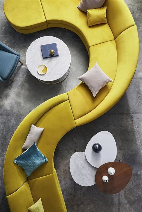an overhead view of a modern living room with yellow couches and white ...