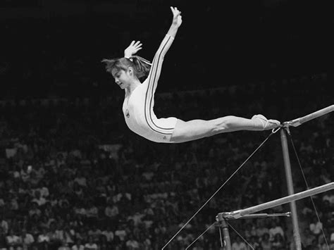 Nadia Comaneci, of Romania, dismounts from the uneven parallel bars at ...