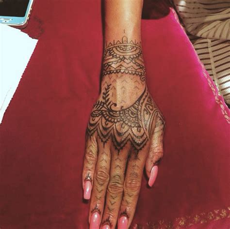 a woman's hand with tattoos on it