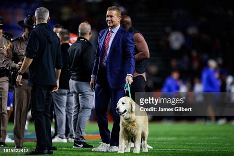 Analyst Kirk Herbstreit and his dog Ben look on before the start of a ...