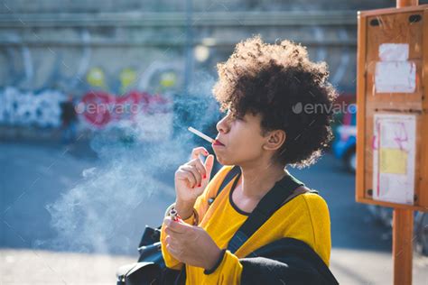 Black woman smoking cigarette outdoor Stock Photo by peus80 | PhotoDune