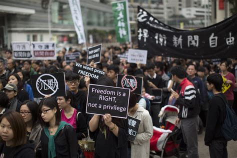 'They can't kill us all': Thousands protest chopper attack on Ming Pao ...