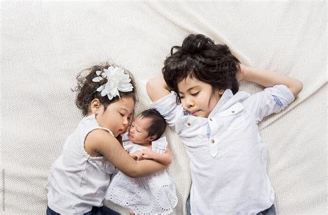 "Siblings Hugging A Newborn Baby" by Stocksy Contributor "Yuko Hirao ...